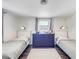 Bright bedroom with two twin beds and a shared dresser at 325 San Benito Ave, North Port, FL 34287