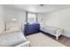Spacious bedroom with two twin beds, a dresser, and a window at 325 San Benito Ave, North Port, FL 34287