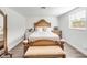 Bright bedroom with wooden bed frame, dresser, and large window at 325 San Benito Ave, North Port, FL 34287