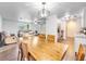 Open concept dining area, featuring a long wooden table and view of living room at 325 San Benito Ave, North Port, FL 34287