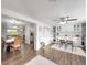 Bright dining room with wood flooring, and view into kitchen at 325 San Benito Ave, North Port, FL 34287