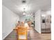 Spacious dining room with wooden table and view into living room and kitchen at 325 San Benito Ave, North Port, FL 34287