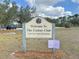 Entrance to The Canine Club dog park, featuring signage and park information at 325 San Benito Ave, North Port, FL 34287