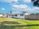 Newly renovated home exterior boasts a white exterior and fenced yard at 325 San Benito Ave, North Port, FL 34287