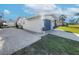 Newly painted garage with gray door and white gravel driveway at 325 San Benito Ave, North Port, FL 34287