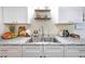 Updated kitchen featuring white shaker cabinets, granite counters, and double sink at 325 San Benito Ave, North Port, FL 34287