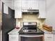 Kitchen showcasing a new gas cooktop and modern overhead range hood at 325 San Benito Ave, North Port, FL 34287