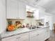 Modern kitchen with white cabinets, granite countertops, and stainless steel appliances at 325 San Benito Ave, North Port, FL 34287