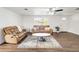 Cozy living room featuring a stylish coffee table and comfortable seating at 325 San Benito Ave, North Port, FL 34287