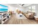 Spacious living room with a comfortable leather couch and ample natural light at 325 San Benito Ave, North Port, FL 34287