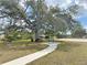 Relaxing park area with a tree, picnic table, and a hanging bench at 325 San Benito Ave, North Port, FL 34287