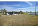 Spacious backyard with grassy lawn and screened patio at 334 Skylark Nw Ln, Port Charlotte, FL 33952
