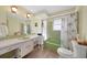 Bathroom with light green bathtub and vanity at 334 Skylark Nw Ln, Port Charlotte, FL 33952