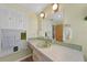 Bathroom with light green vanity and sink at 334 Skylark Nw Ln, Port Charlotte, FL 33952