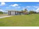 Ranch-style home with attached garage, and spacious lawn at 334 Skylark Nw Ln, Port Charlotte, FL 33952