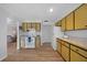 Galley kitchen with yellow cabinets and white appliances at 334 Skylark Nw Ln, Port Charlotte, FL 33952