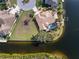 Aerial view of the home showcasing its pool, tile roof, and waterfront location with private dock at 3507 Marsala Ct, Punta Gorda, FL 33950