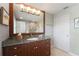 Bathroom with dark wood cabinets and large mirror at 3507 Marsala Ct, Punta Gorda, FL 33950