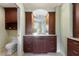 Bathroom vanity with granite counters and framed mirror at 3507 Marsala Ct, Punta Gorda, FL 33950