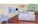 Bedroom featuring hardwood floors, ceiling fan and a mirrored closet at 3507 Marsala Ct, Punta Gorda, FL 33950