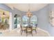 Elegant dining area with a glass table, wicker chairs, and large windows overlooking the pool and waterfront at 3507 Marsala Ct, Punta Gorda, FL 33950
