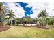 Screened lanai of home surrounded by lush landscaping, offering a private outdoor space for relaxation at 3507 Marsala Ct, Punta Gorda, FL 33950