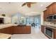 Spacious kitchen featuring granite counters, stainless steel appliances, and a view of the dining area and pool at 3507 Marsala Ct, Punta Gorda, FL 33950