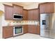 Modern kitchen with stainless steel appliances, stylish cabinetry, and granite countertops, designed for convenience and elegance at 3507 Marsala Ct, Punta Gorda, FL 33950