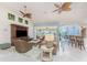 Spacious living room with a large entertainment center, tile floors, and access to outdoor area at 3507 Marsala Ct, Punta Gorda, FL 33950
