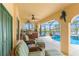 Covered patio with outdoor seating, kitchen, and view of pool and waterfront at 3507 Marsala Ct, Punta Gorda, FL 33950