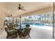 Screened-in patio with comfortable seating overlooking the pool and waterfront view at 3507 Marsala Ct, Punta Gorda, FL 33950
