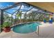 Enclosed pool area with spa and lush landscaping overlooking water at 3507 Marsala Ct, Punta Gorda, FL 33950