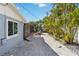 Backyard with gravel landscaping, palm trees and screened enclosure at 351 S Mccall Rd, Englewood, FL 34223