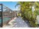Backyard with gravel, tropical plants and screened pool area at 351 S Mccall Rd, Englewood, FL 34223