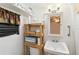 Clean bathroom with a pedestal sink, toilet, and wooden shelving at 351 S Mccall Rd, Englewood, FL 34223