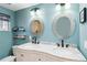 Bathroom boasts a double vanity with marble countertop and large oval mirrors at 351 S Mccall Rd, Englewood, FL 34223