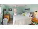 Primary bedroom with striped bedding and private access to the patio at 351 S Mccall Rd, Englewood, FL 34223