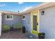 Inviting front entry featuring a cheerful yellow door and a charming patio at 351 S Mccall Rd, Englewood, FL 34223