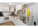 White kitchen with granite countertops and stainless steel appliances at 351 S Mccall Rd, Englewood, FL 34223