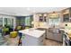 Open-concept kitchen and living area with stylish gray cabinetry at 351 S Mccall Rd, Englewood, FL 34223