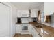 White kitchen with granite countertops and stainless steel appliances at 351 S Mccall Rd, Englewood, FL 34223