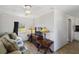 Living room with a sofa, TV, and wooden side table at 351 S Mccall Rd, Englewood, FL 34223
