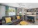Cozy living room with gray sofa and kitchen island at 351 S Mccall Rd, Englewood, FL 34223