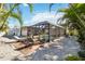 Screened pool and patio with lounge chairs and tropical landscaping at 351 S Mccall Rd, Englewood, FL 34223