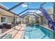 Enclosed pool and spa area with patio furniture and screened enclosure at 351 S Mccall Rd, Englewood, FL 34223