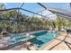 Screened pool and spa with tiled deck and tropical landscaping at 351 S Mccall Rd, Englewood, FL 34223