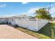 Landscaped side yard with brick pavers and a white fence at 351 S Mccall Rd, Englewood, FL 34223
