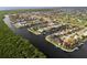 Aerial view of a canal-front community with many houses and green spaces at 3800 Carupano Ct, Punta Gorda, FL 33950