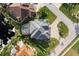 Directly above view of a home with a gray roof, pool, and paved driveway at 3800 Carupano Ct, Punta Gorda, FL 33950