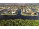 Aerial perspective showcasing waterfront homes and lush vegetation along the canal at 3800 Carupano Ct, Punta Gorda, FL 33950